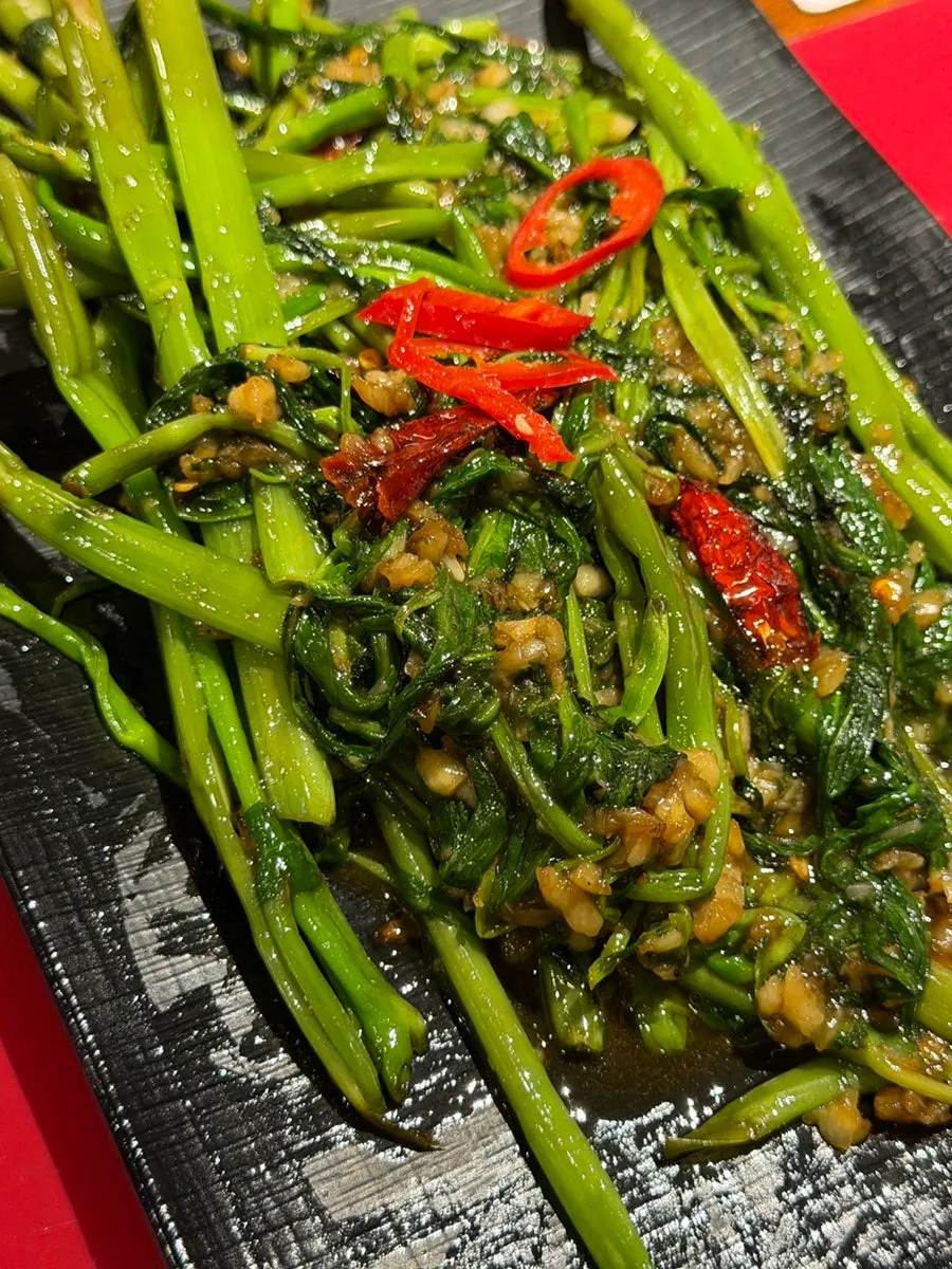 A spoonful of garlic scape fried rice lifted up