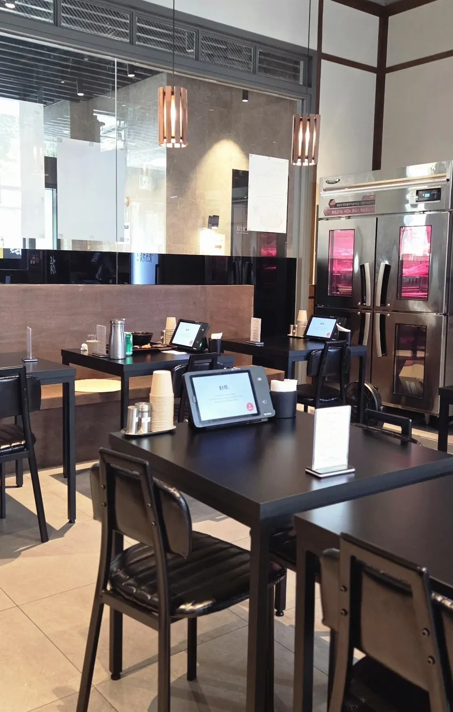 Interior of Hunta Euljiro decorated with wood and black tables