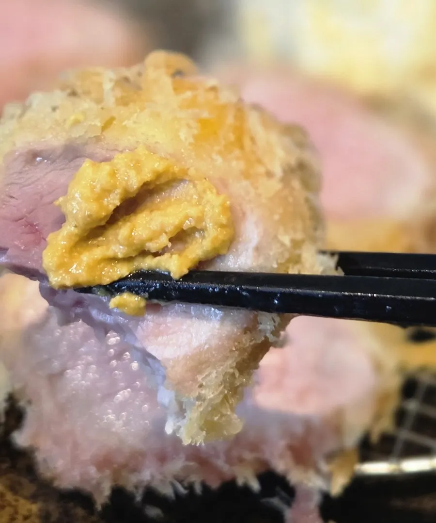 A piece of fillet katsu dipped in salt