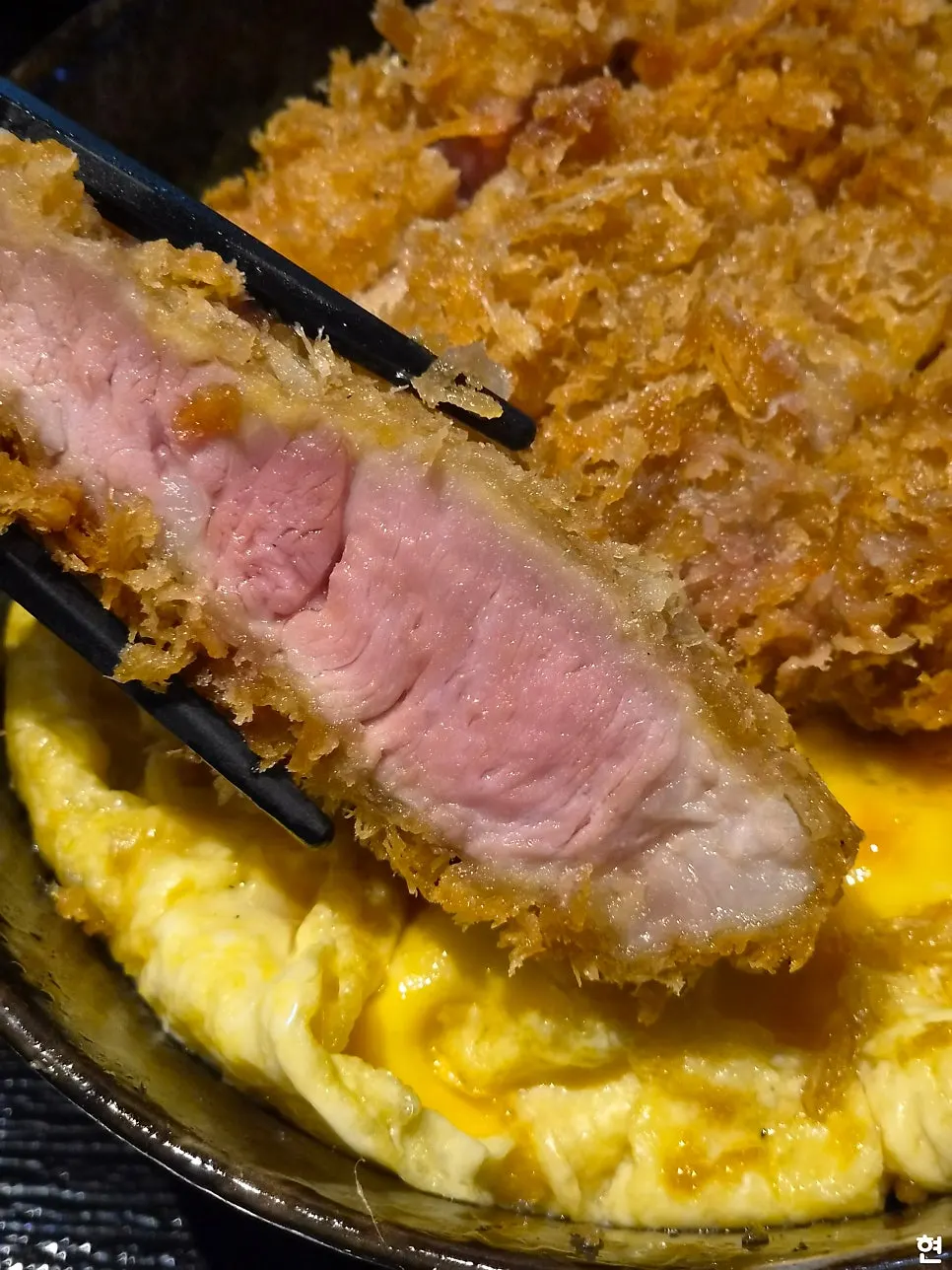 Close-up of the kataroSu tare katsudon topped with egg