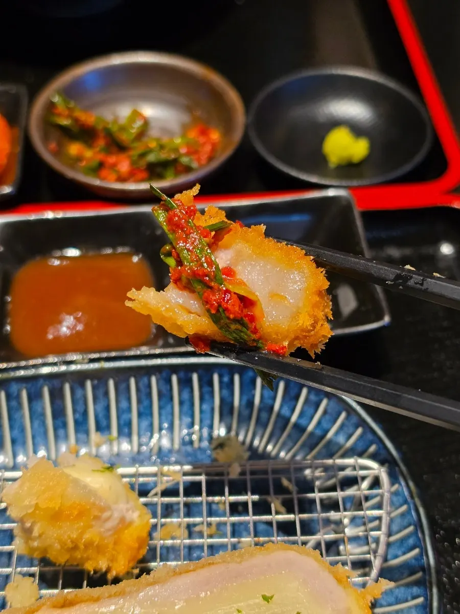 Scallion kimchi placed on top of katsudon