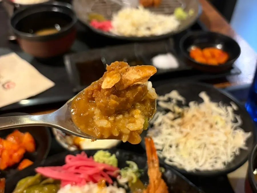 Curry topped with two large fried shrimp