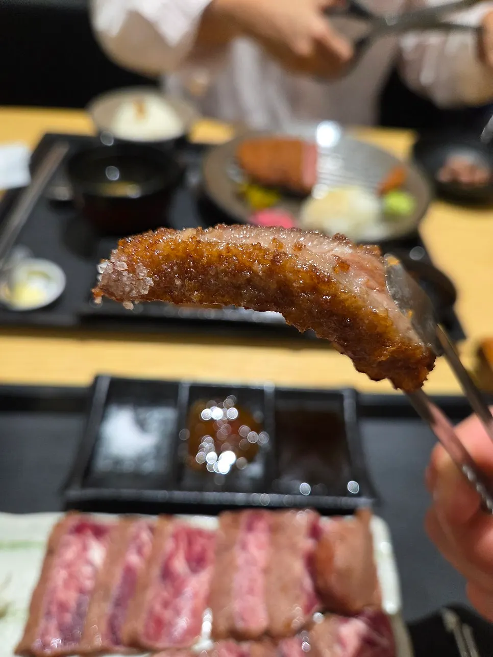 A piece of grilled gyukatsu from the tabletop grill