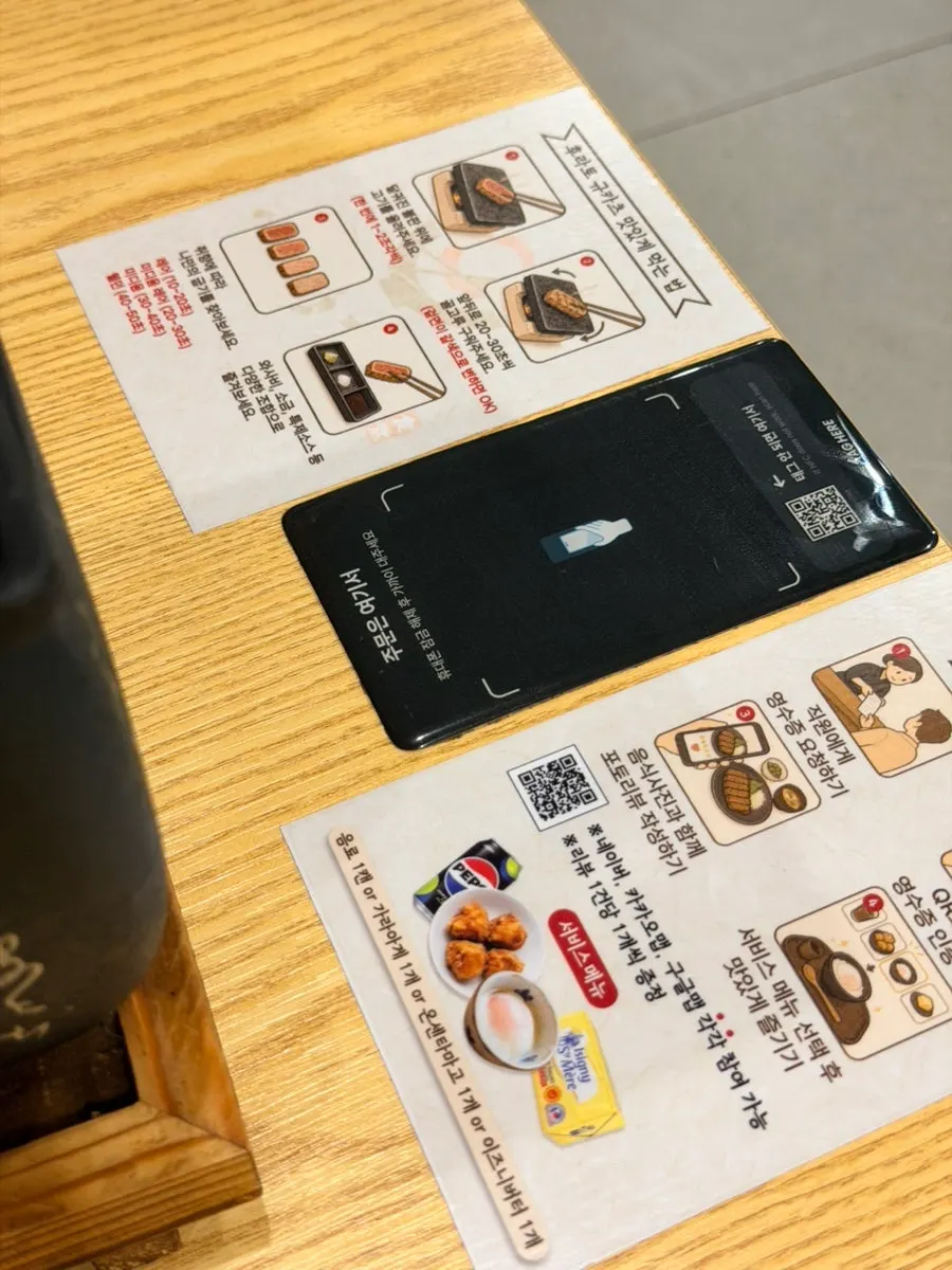 Table sign explaining phone-recognition and QR code ordering