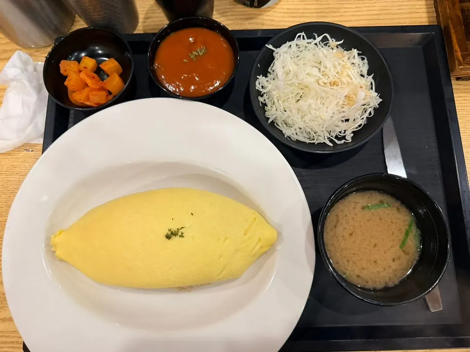 Omurice set served with doenjang soup, salad and diced radish kimchi
