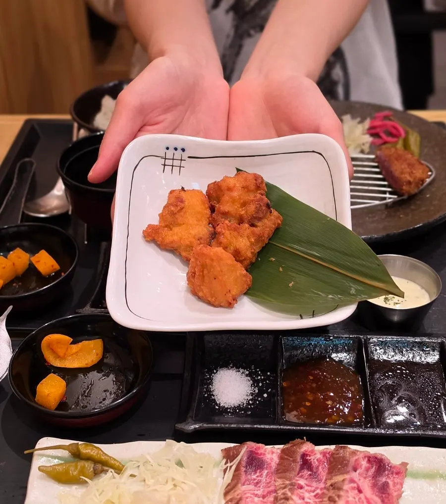 Picking up a piece of buttered gyukatsu