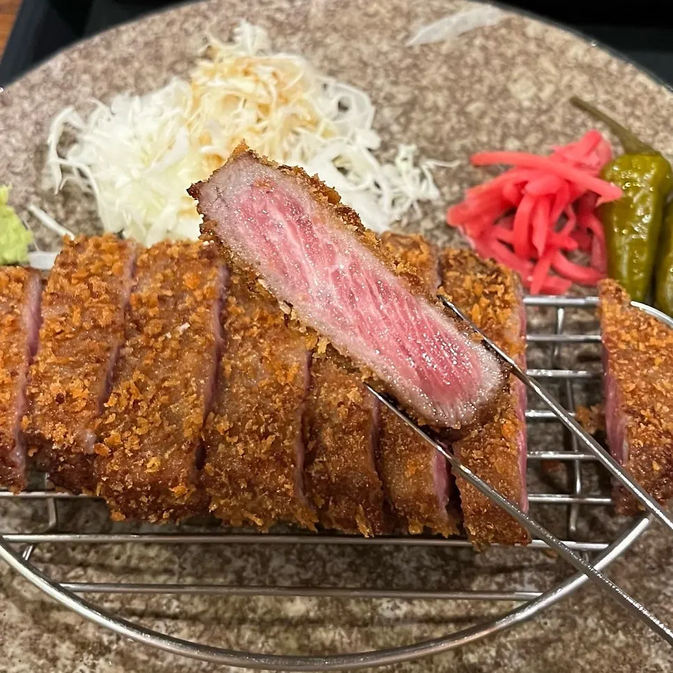 A slice of gyukatsu showing its bright red center