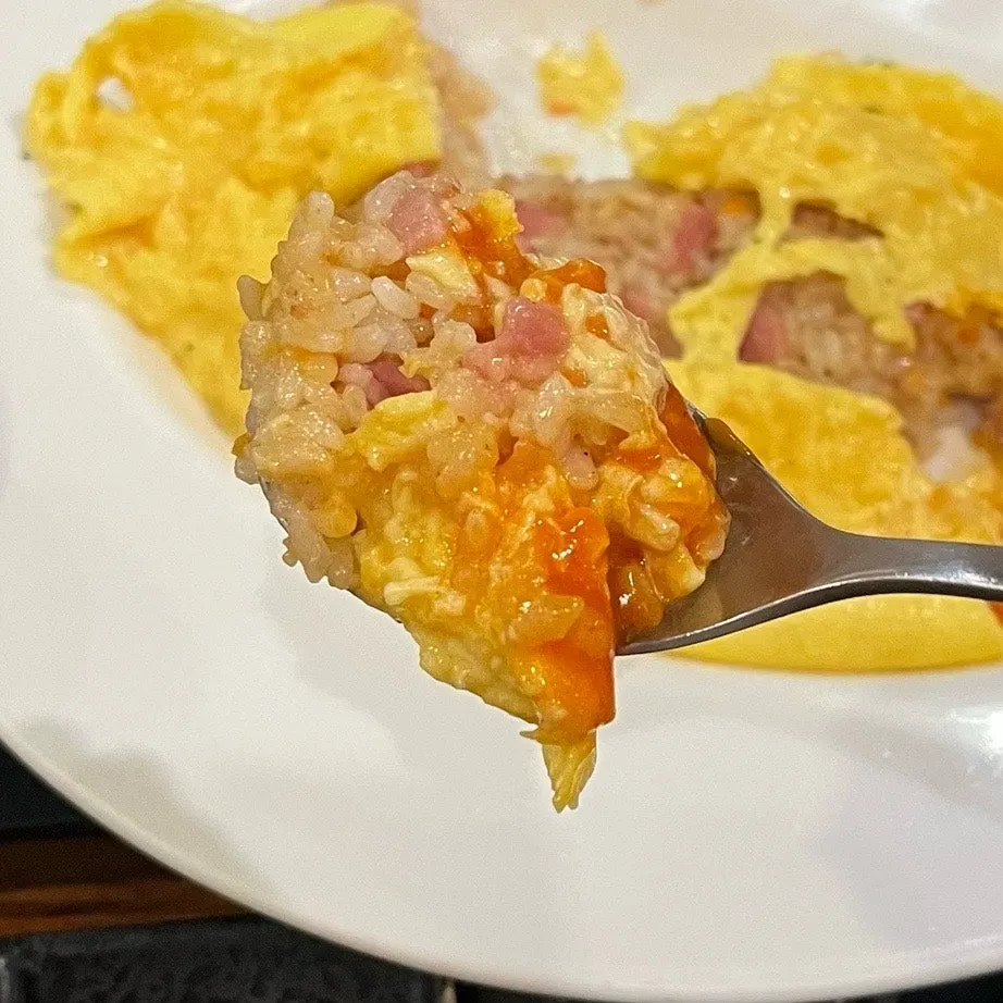 Omurice topped with tomato-based signature sauce