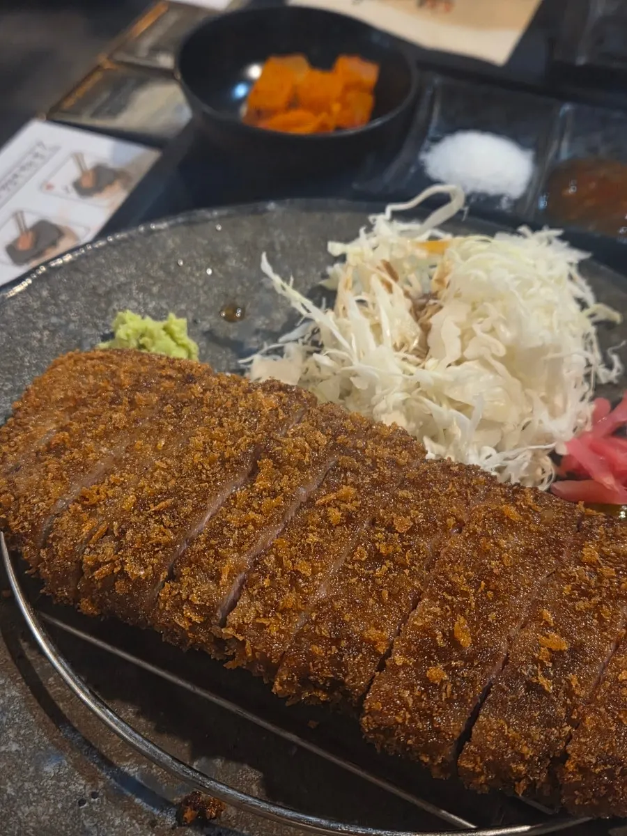Plate of gyukatsu served with cabbage and wasabi