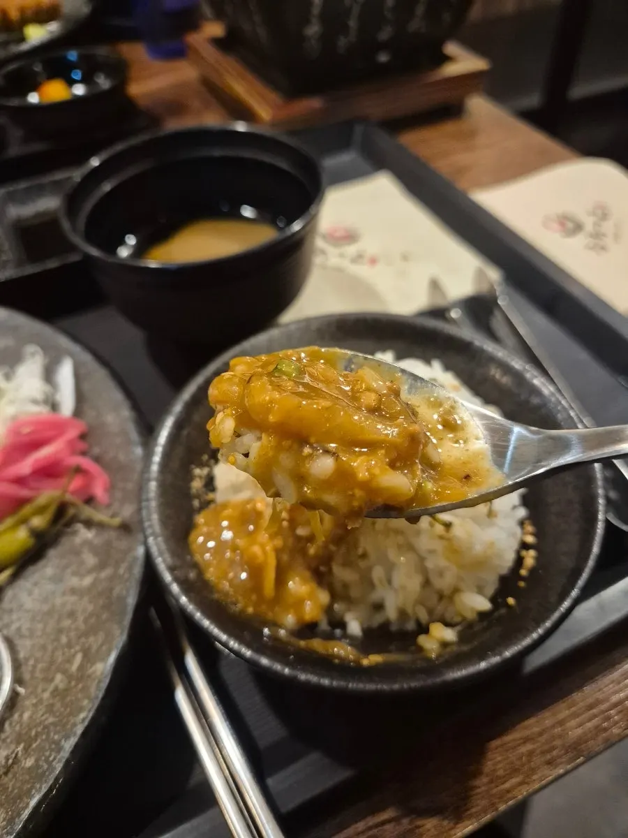 A piece of gyukatsu topped with fresh wasabi