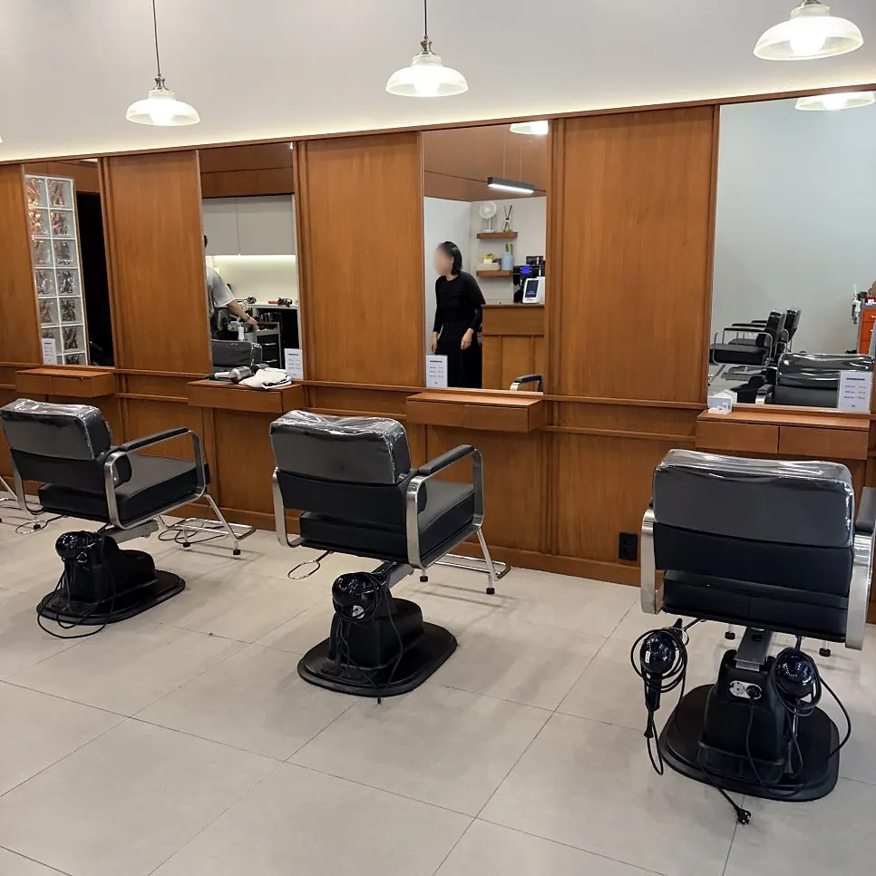 Salon interior showing reservation-only notice
