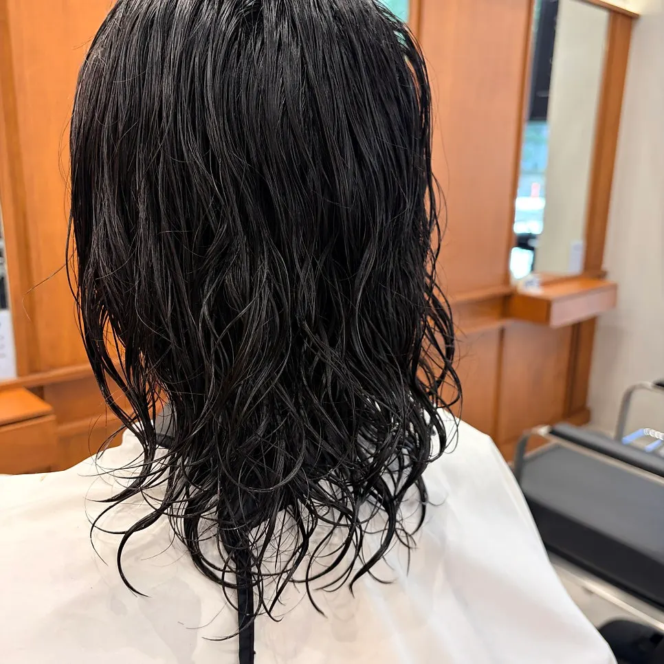 The director examining the hair's condition