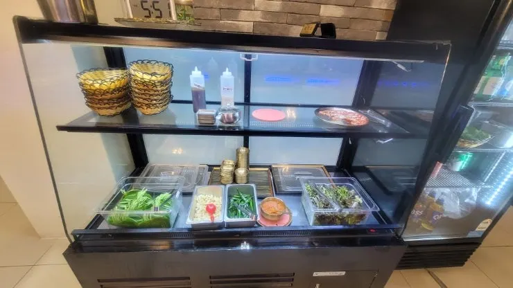 Hwadamga's self-serve bar corner lined with side dishes