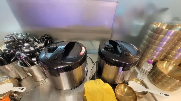 Self-serve bar display with salad and kimchi