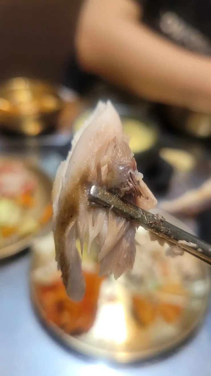 The moist inside of the crisp grilled mackerel