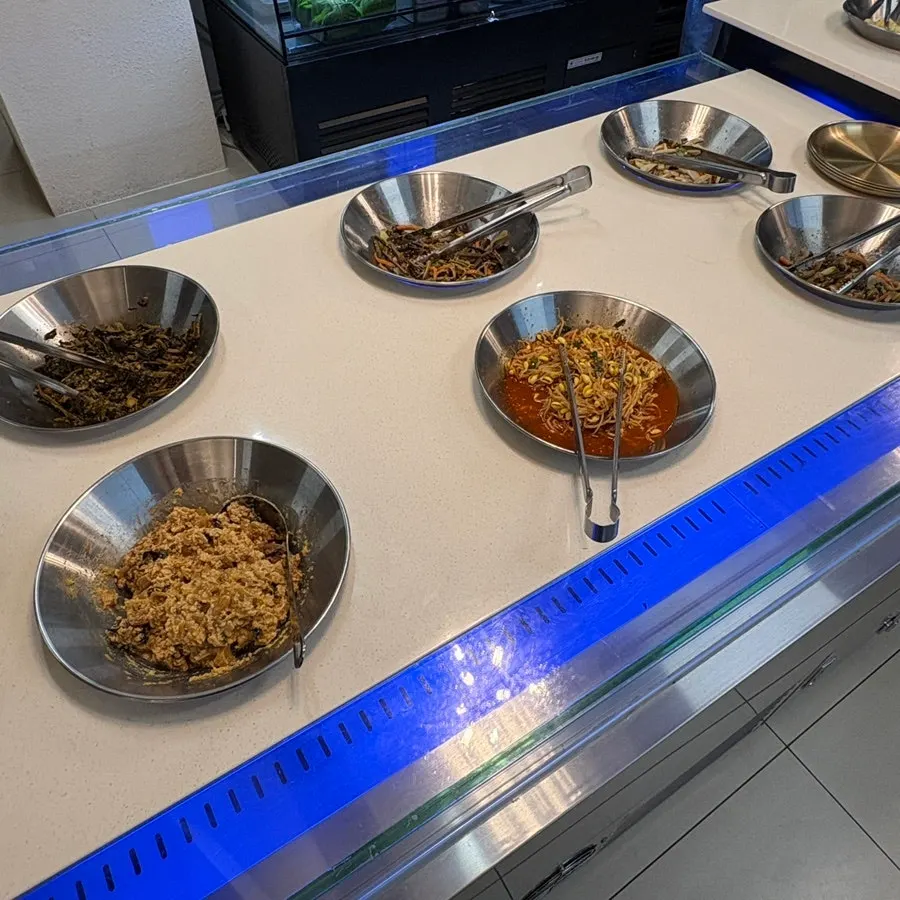 Various seasoned namul side dishes at the self-serve corner