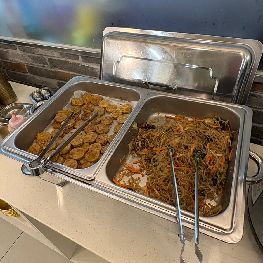A plate with meat patties and japchae