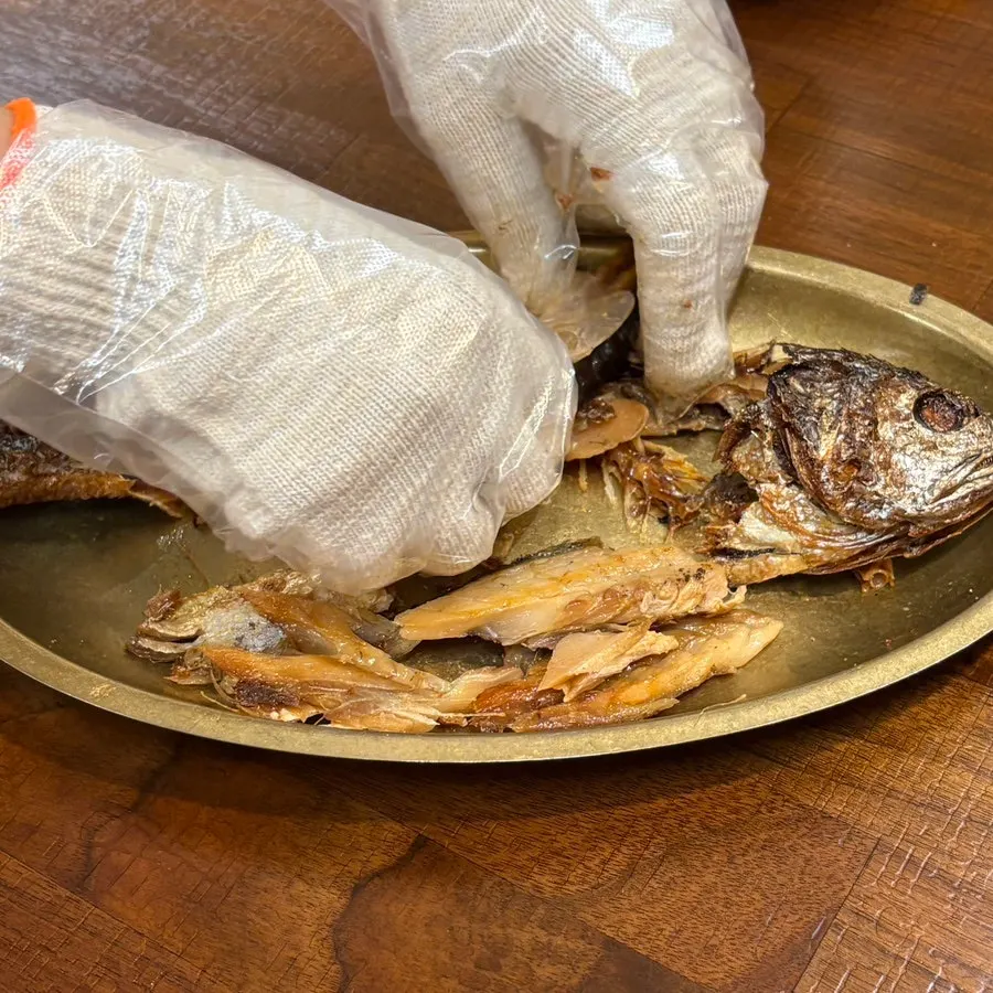 A staff member deboning the bori-gulbi
