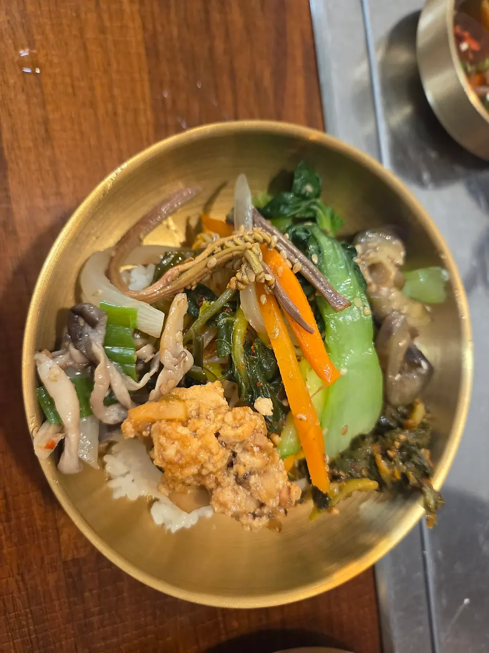 Bowl of bibimbap with sesame oil and gochujang added