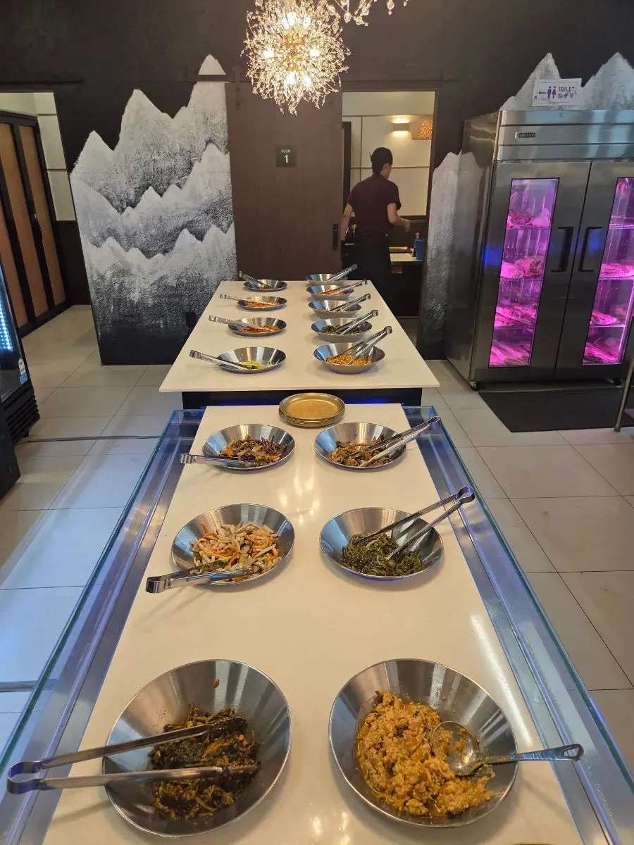Vertical photo of Hwadamga's wood-fired grilled fish set