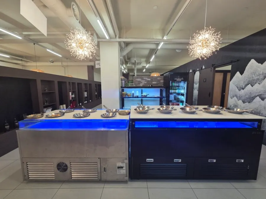 Seasoned vegetable side dishes and lettuce wraps on the self-serve bar