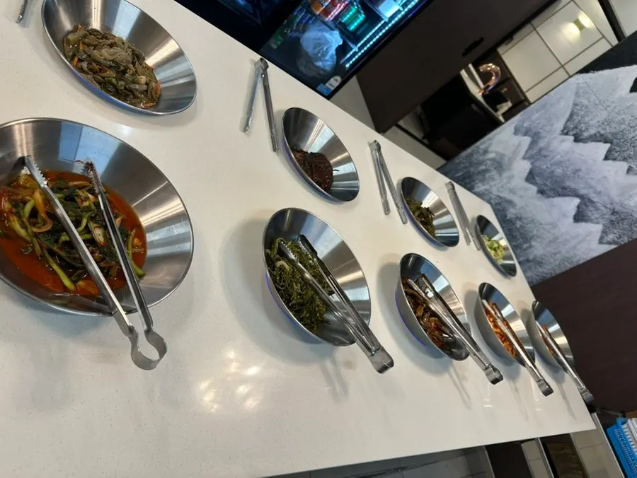 Self-serve bar with japchae and Korean-style meat patties