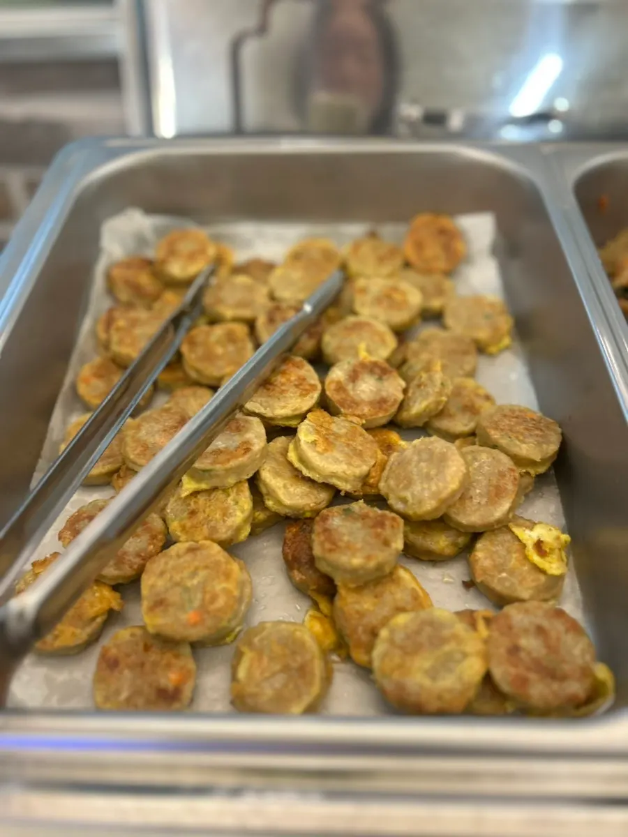 Seasoned vegetable side dishes at Hwadamga's self-serve bar
