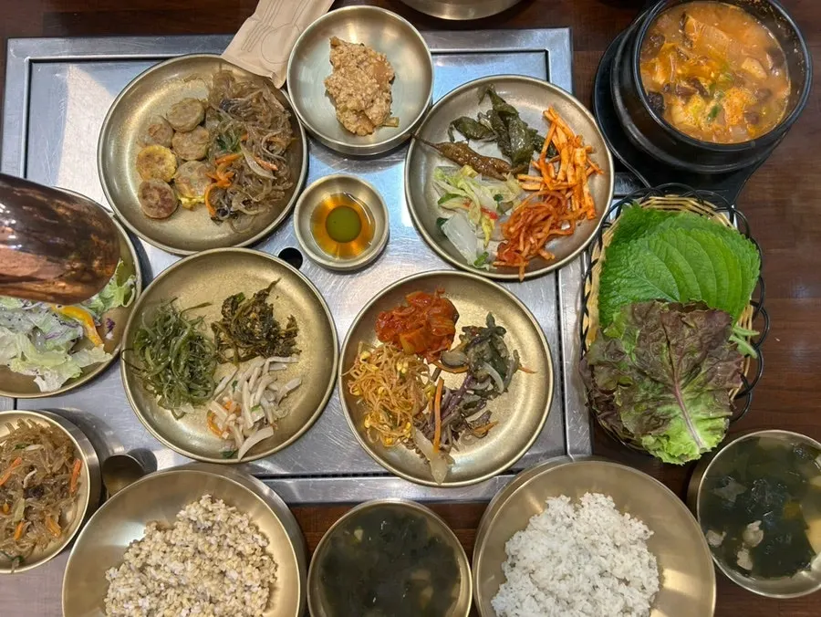 Table with seaweed soup, ssamjang, garlic, and chili peppers