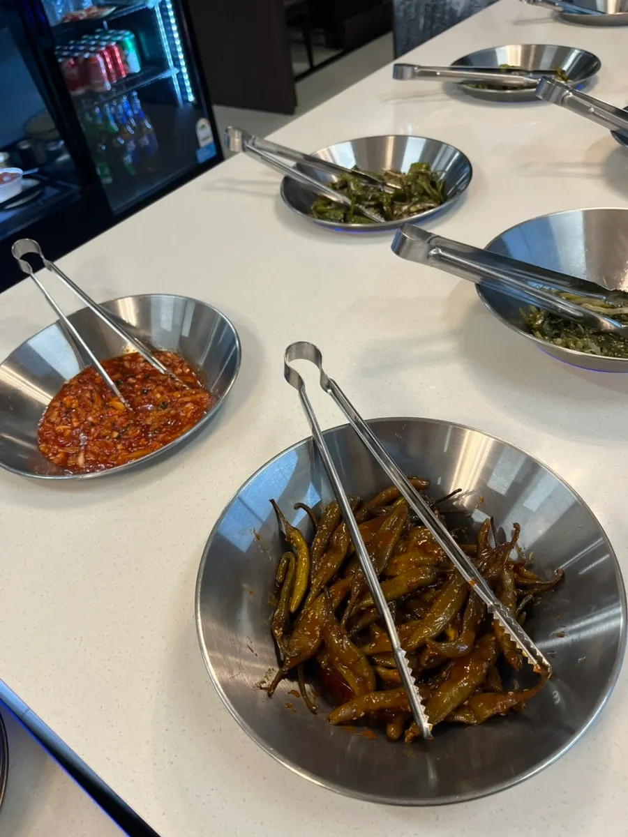 Seasoned vegetable sides at Hwadamga's self-serve bar