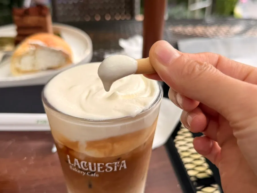 A glass of golden-yellow apple mango smoothie