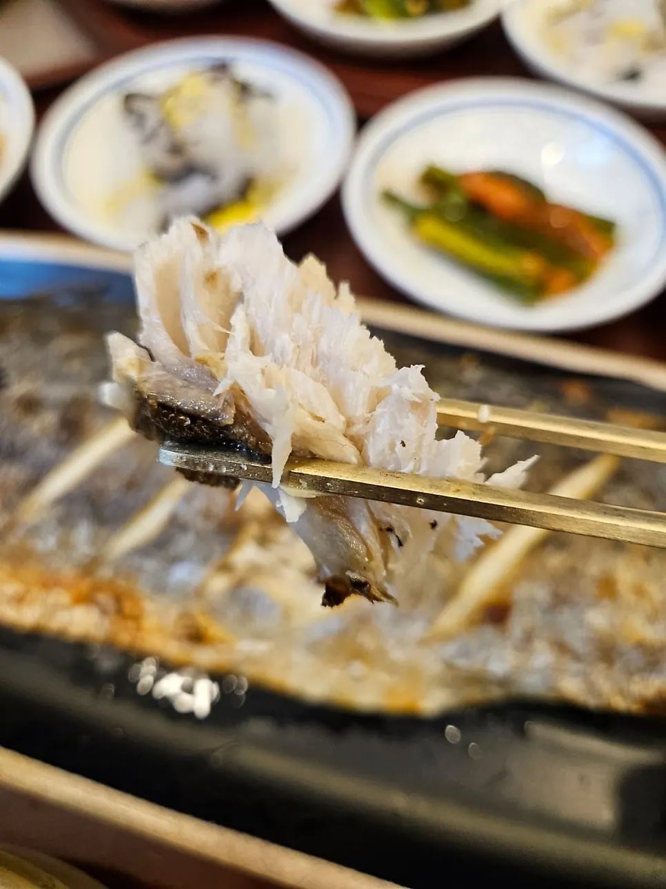 Thick fish flesh pulled apart with chopsticks