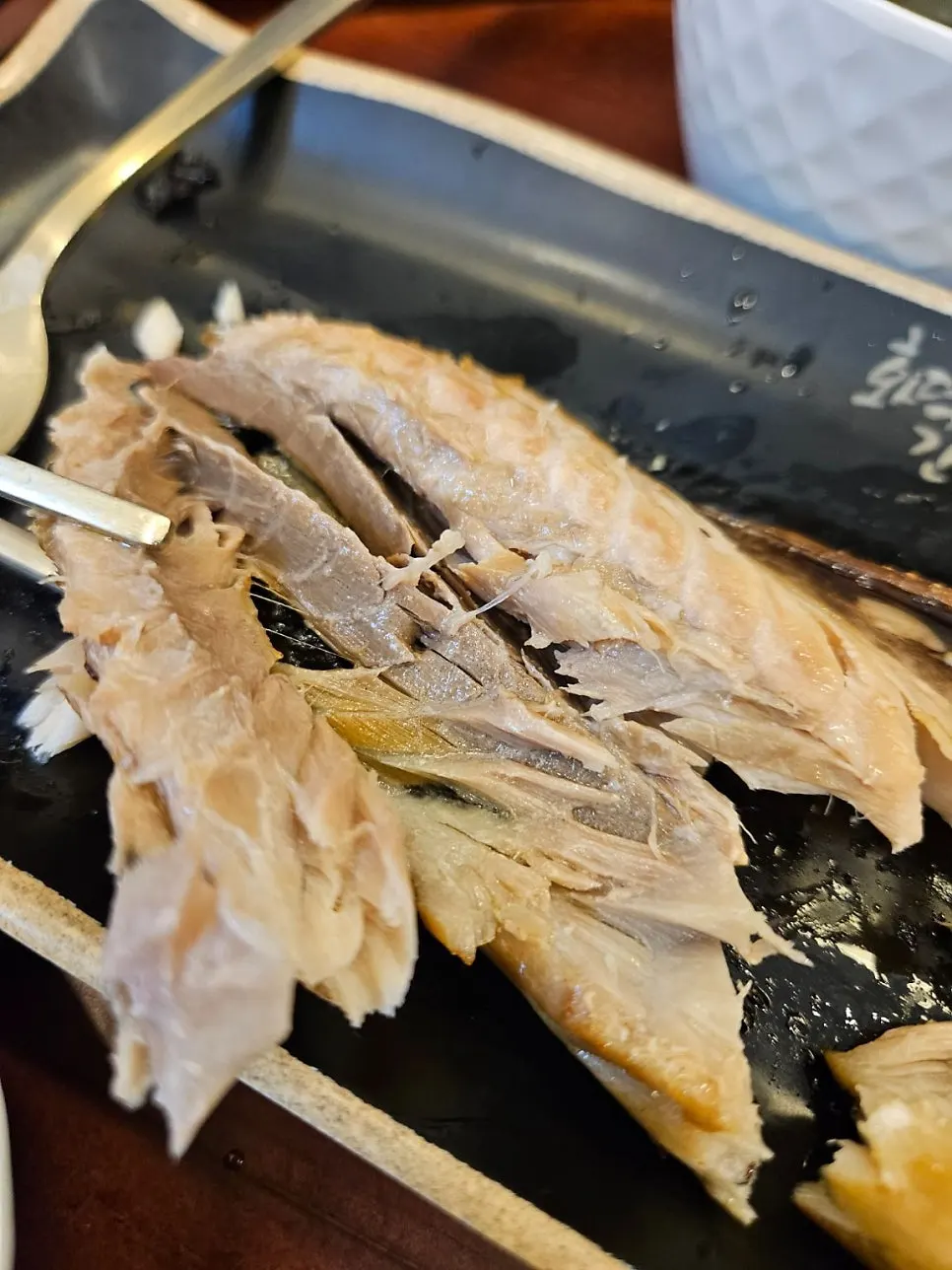 Fish flesh topped with wasabi dipped in soy sauce