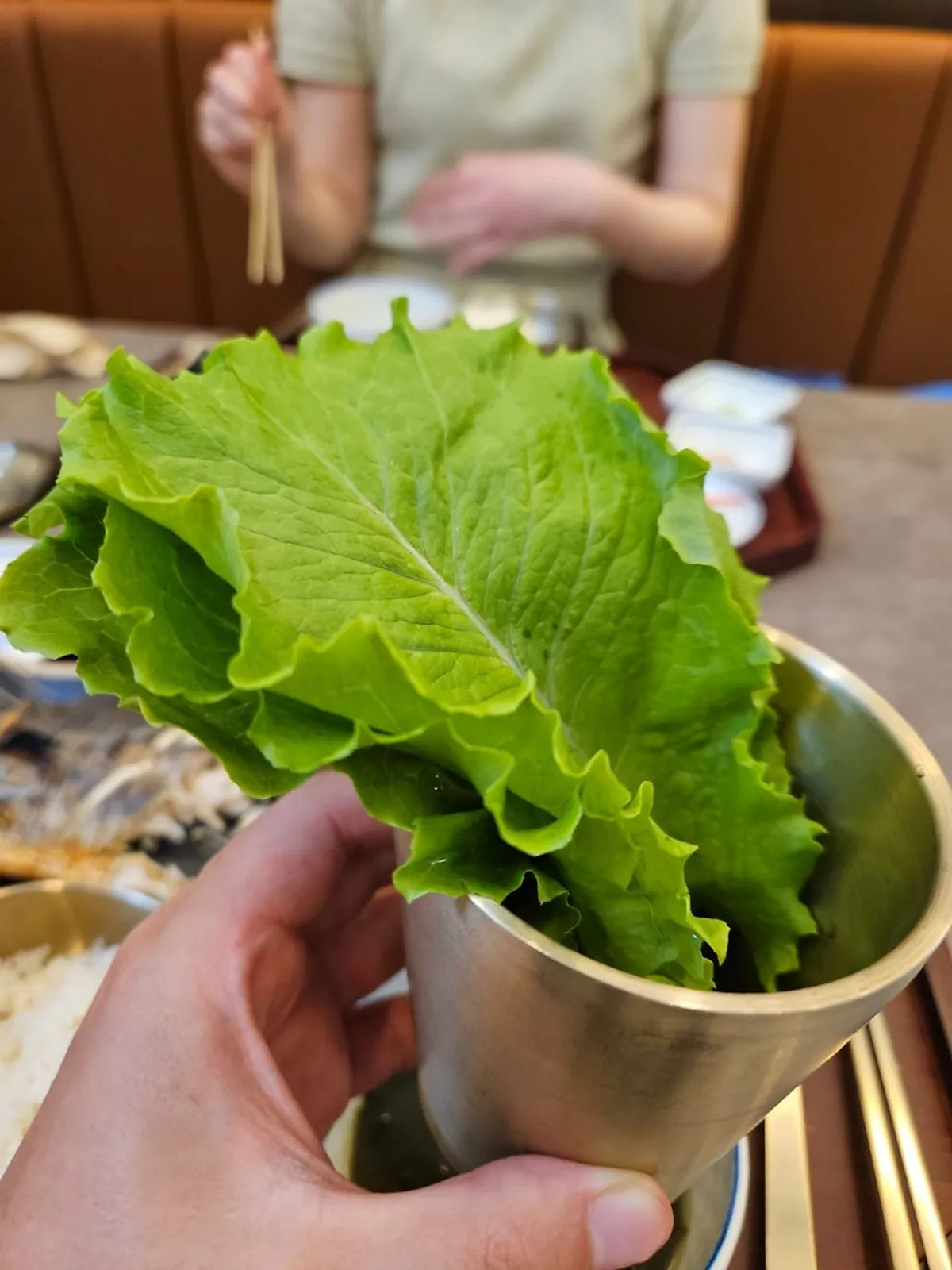 Lettuce wrap with rice and fish on top