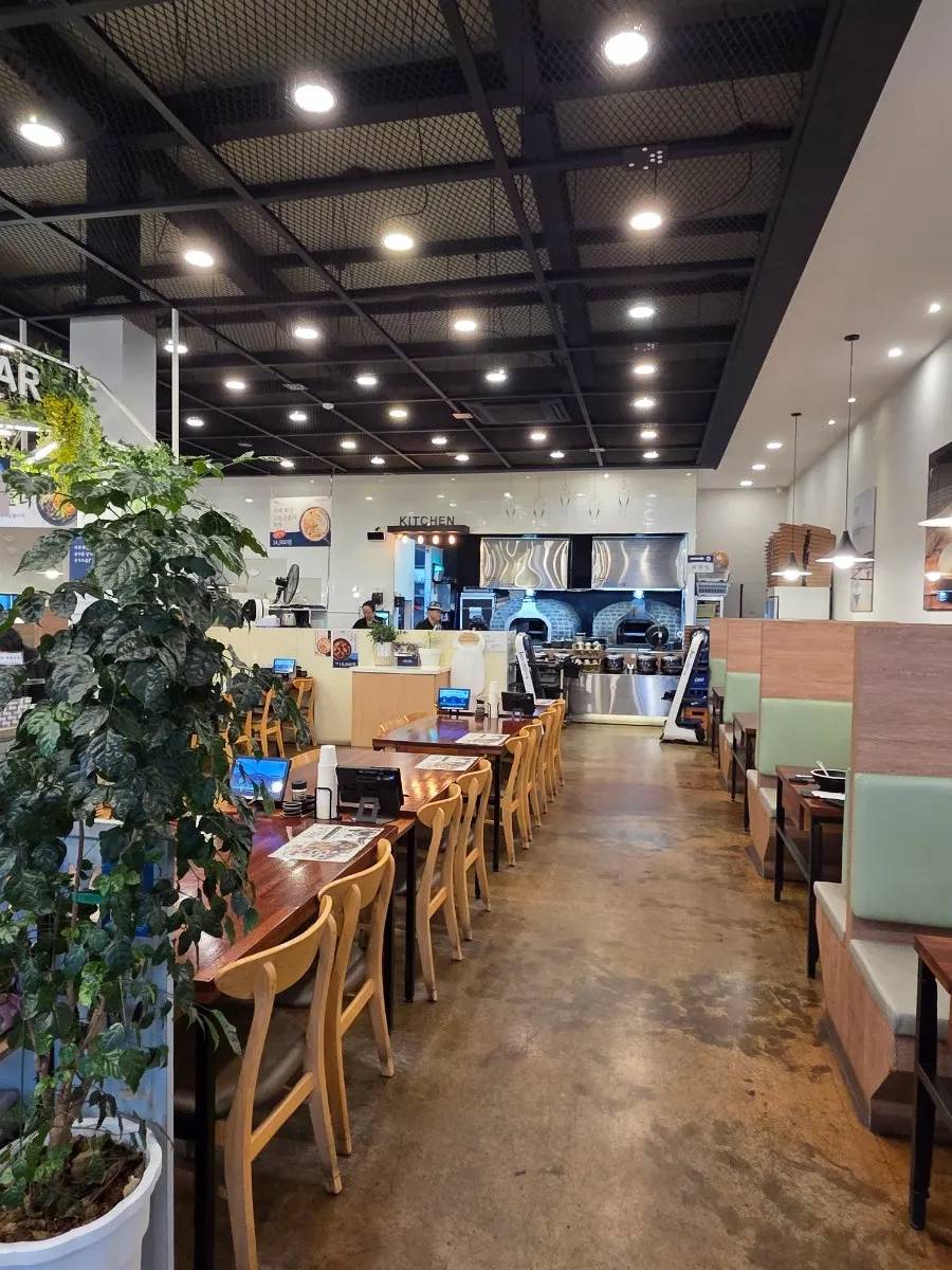 Restaurant interior showing the wood-fired oven by the open kitchen