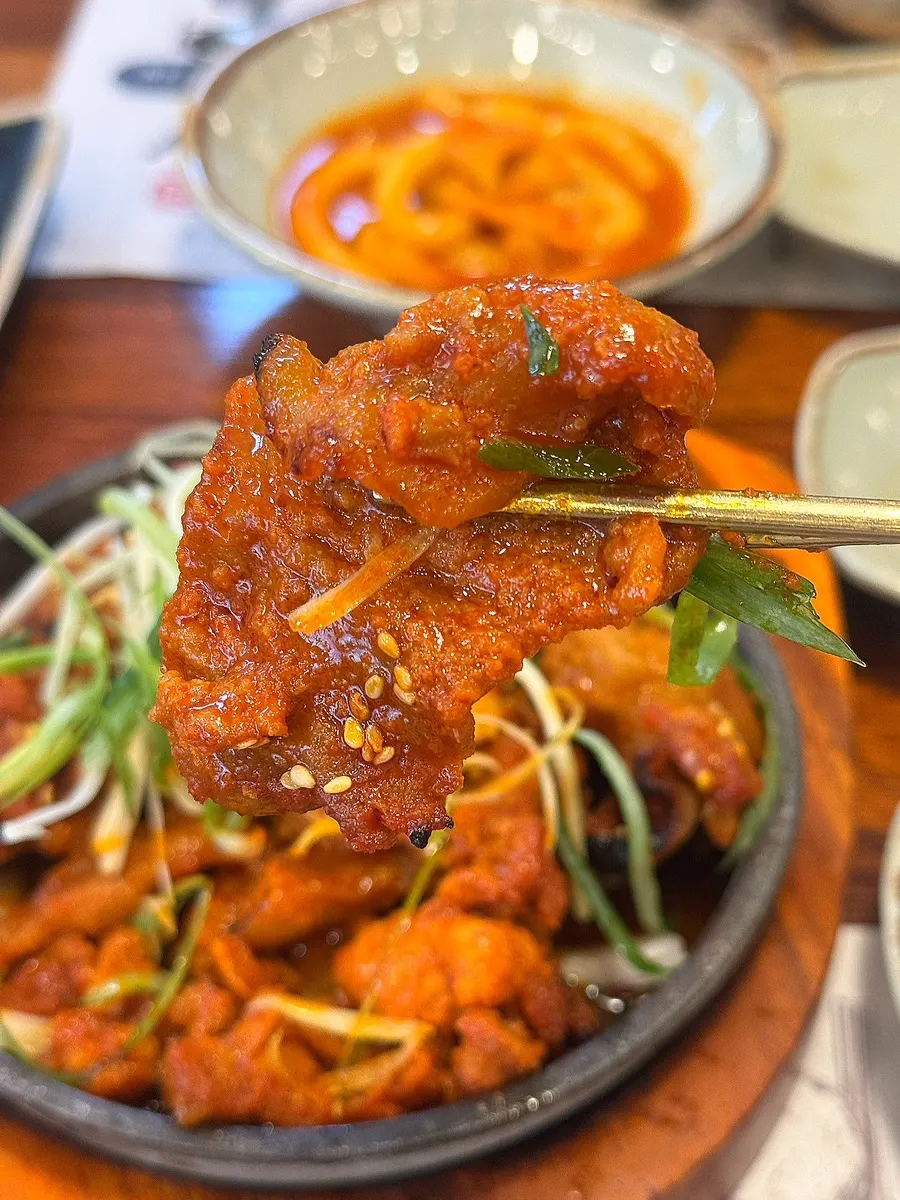 A piece of pork bulgogi placed over brown rice