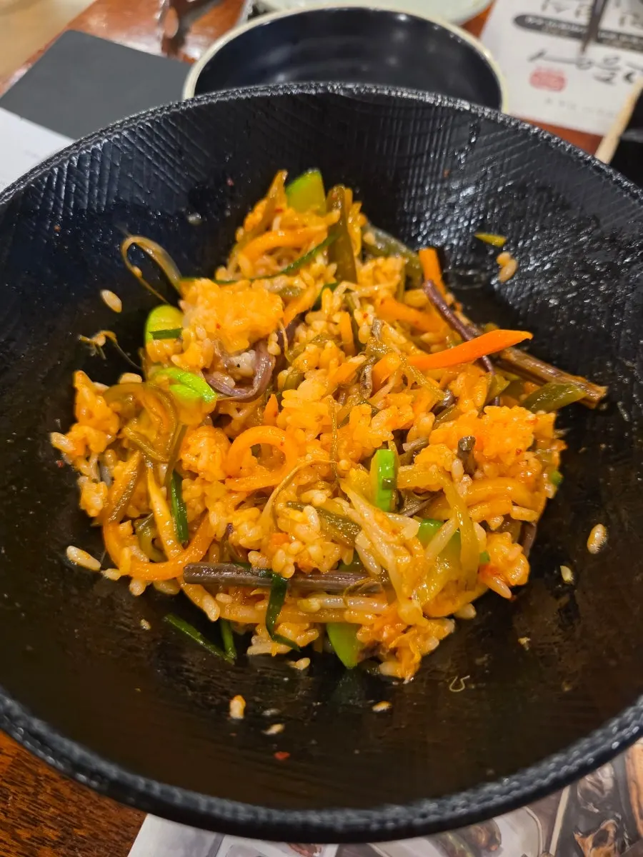 A bowl of bibimbap before mixing