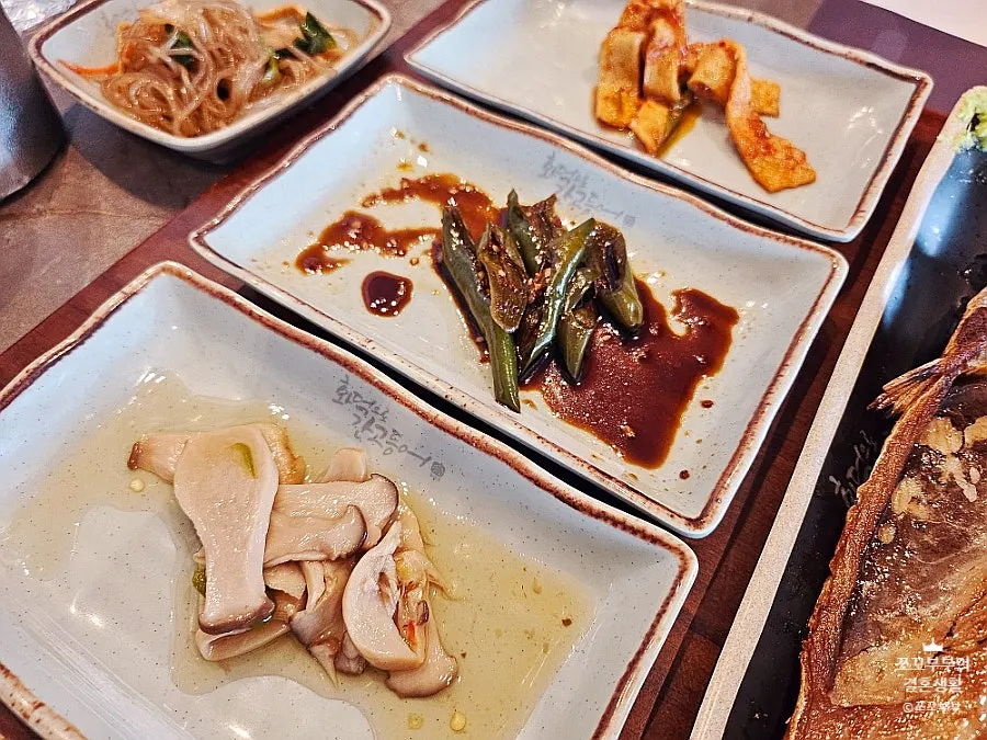 Table set with grilled fish and side dishes