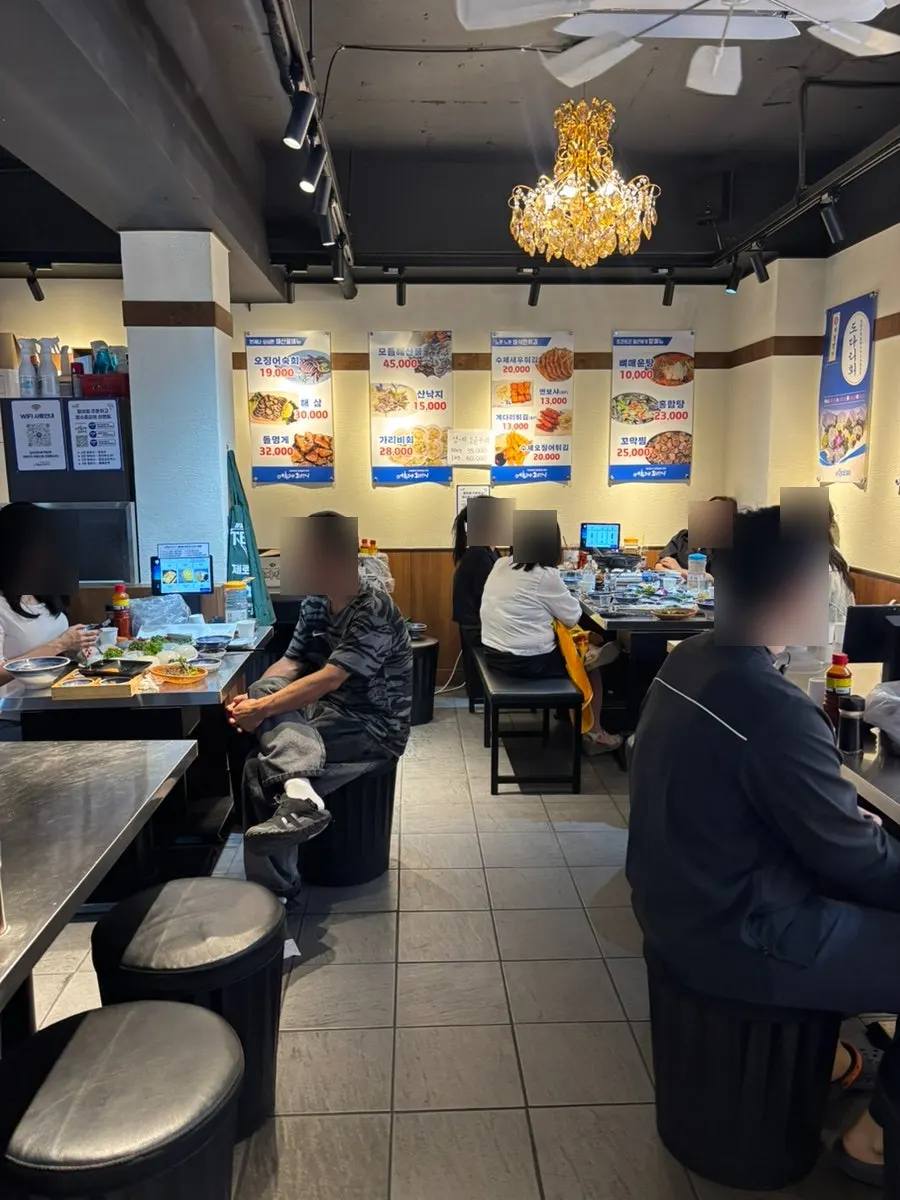 Large menu board hanging in the middle of the restaurant
