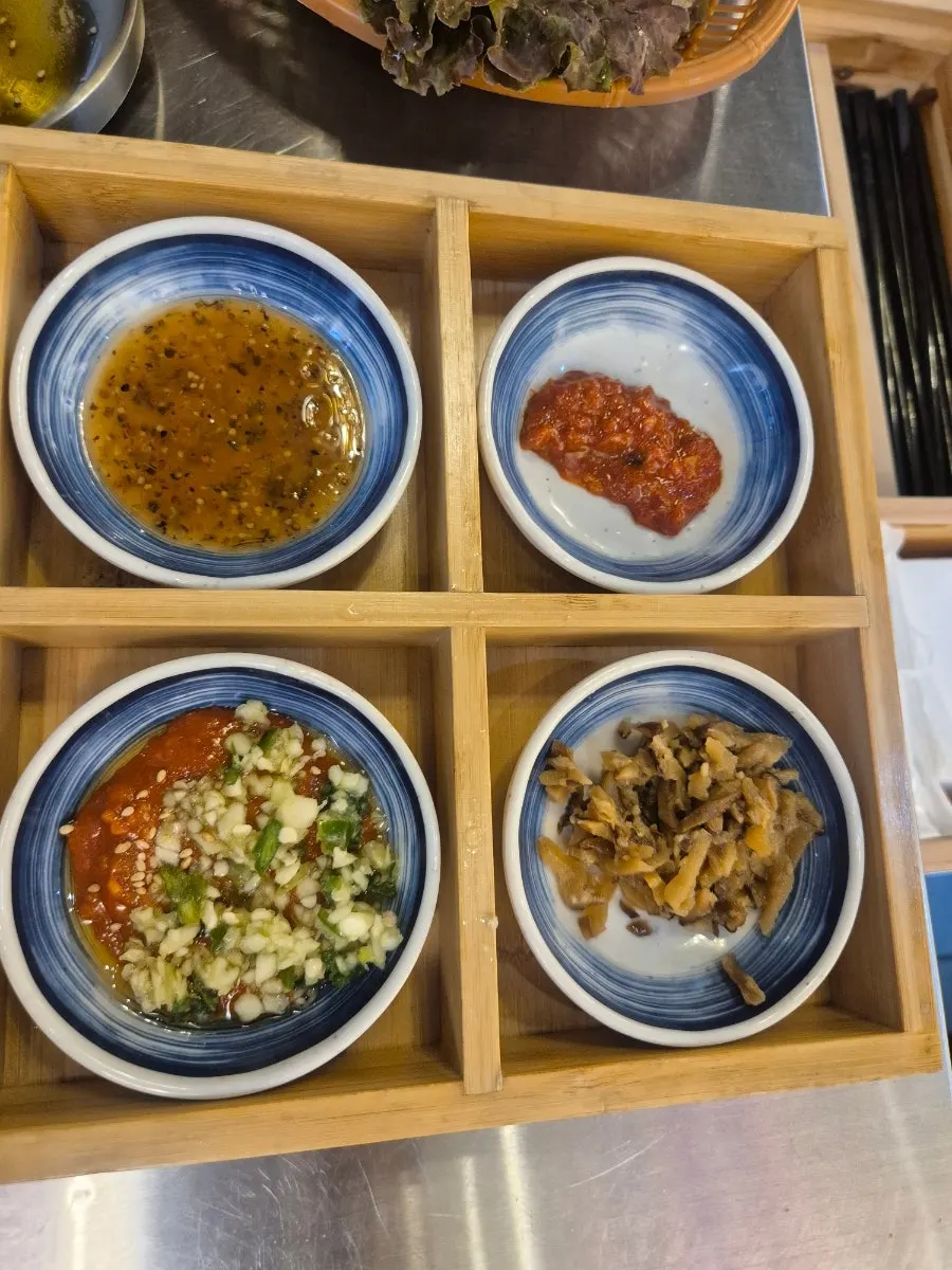 Five sauces including sesame oil, plus vegetables