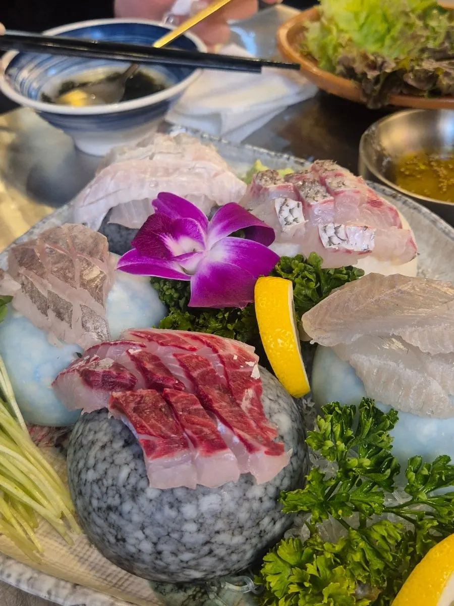 Table with sashimi and side dishes