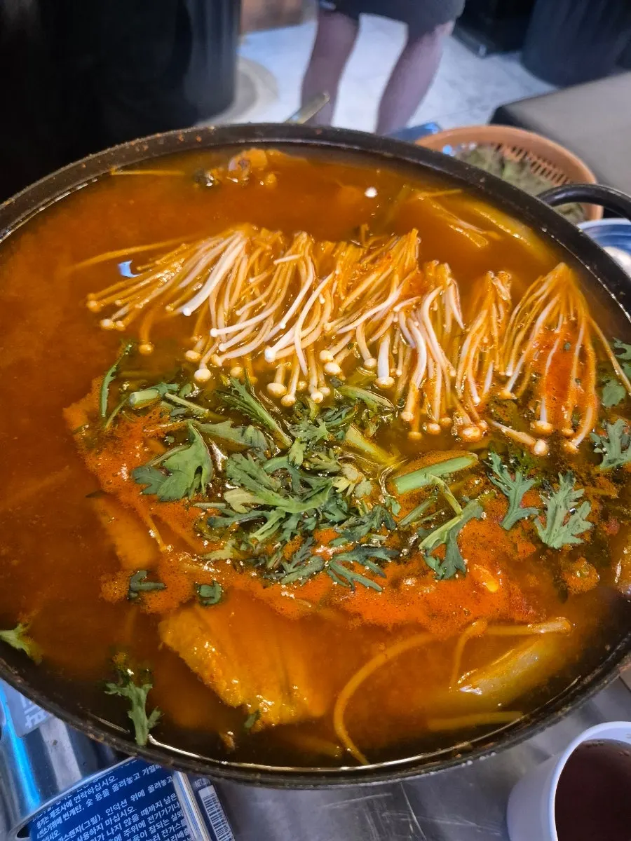 Fish bone spicy soup packed with bones and enoki mushrooms