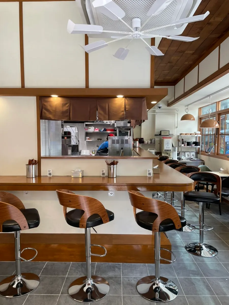 Calm Japanese restaurant interior with mostly bar seating