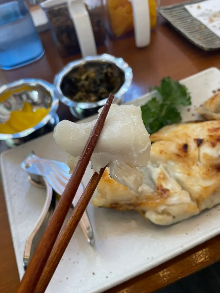 A piece of salt-grilled black cod pulled apart
