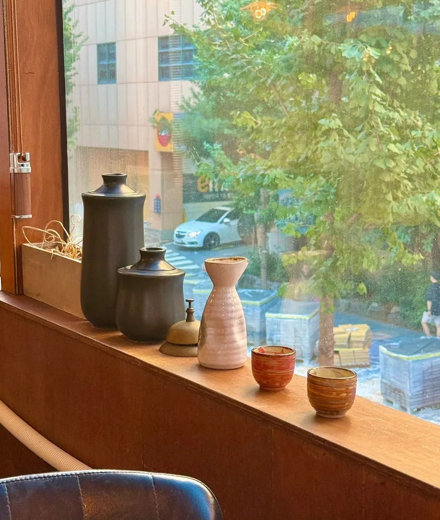 Interior of the Japanese restaurant with a floor-to-ceiling window and decor