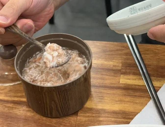 Pyeonyuk served with onion, ssamjang, and salted shrimp