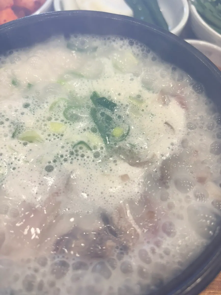 A steaming bowl of sundae-guk in a stone pot