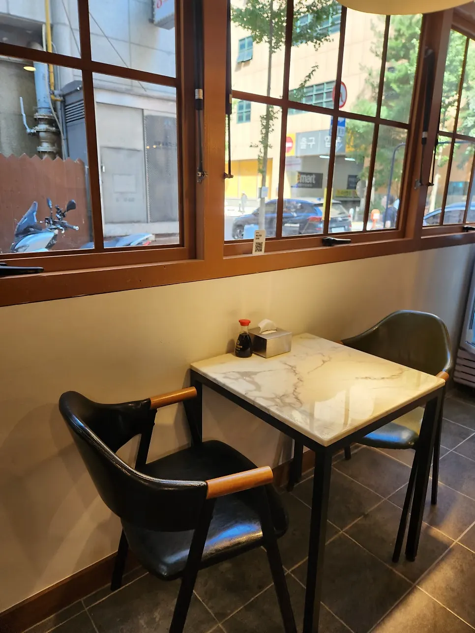 Warm wood-toned counter seating inside Min Cook Misoyaki