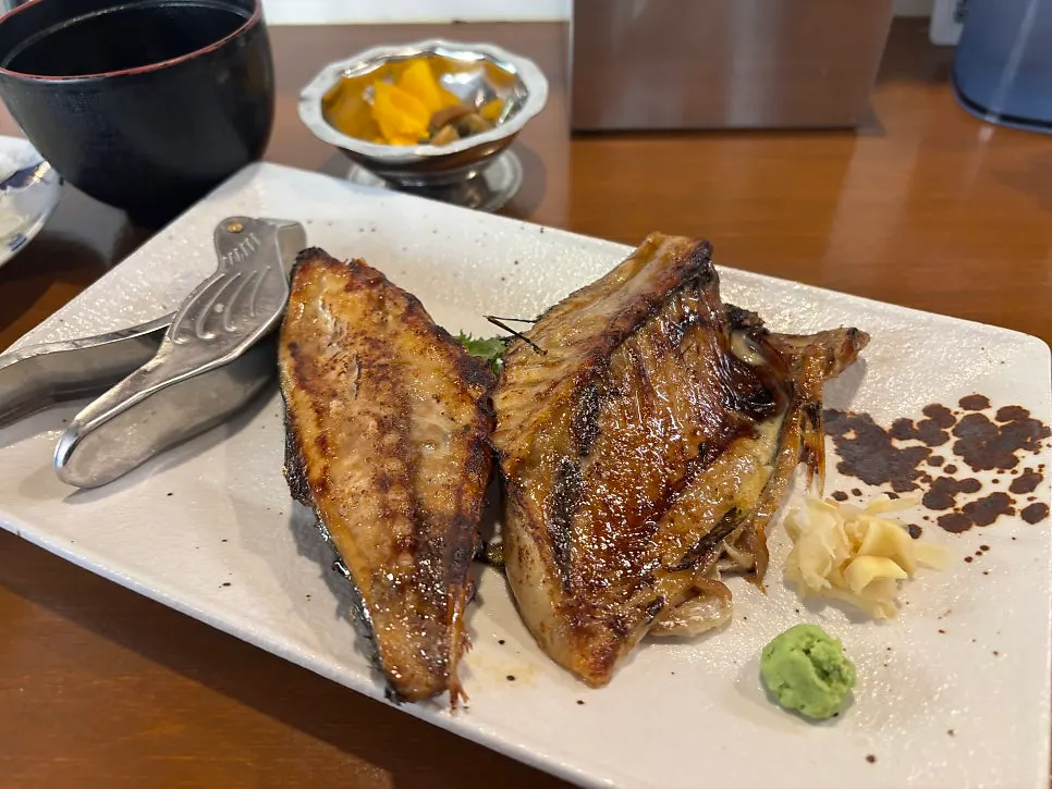 A table set for three at the counter seats with grilled fish