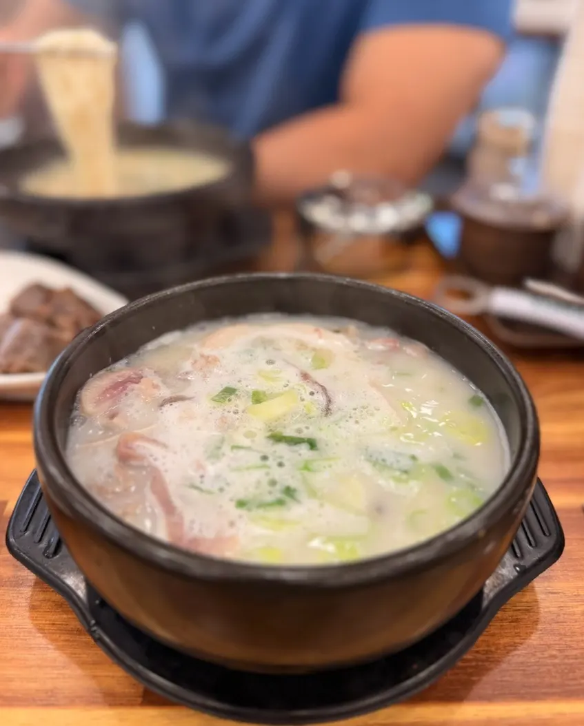 Sundae-guk served in a black earthenware bowl
