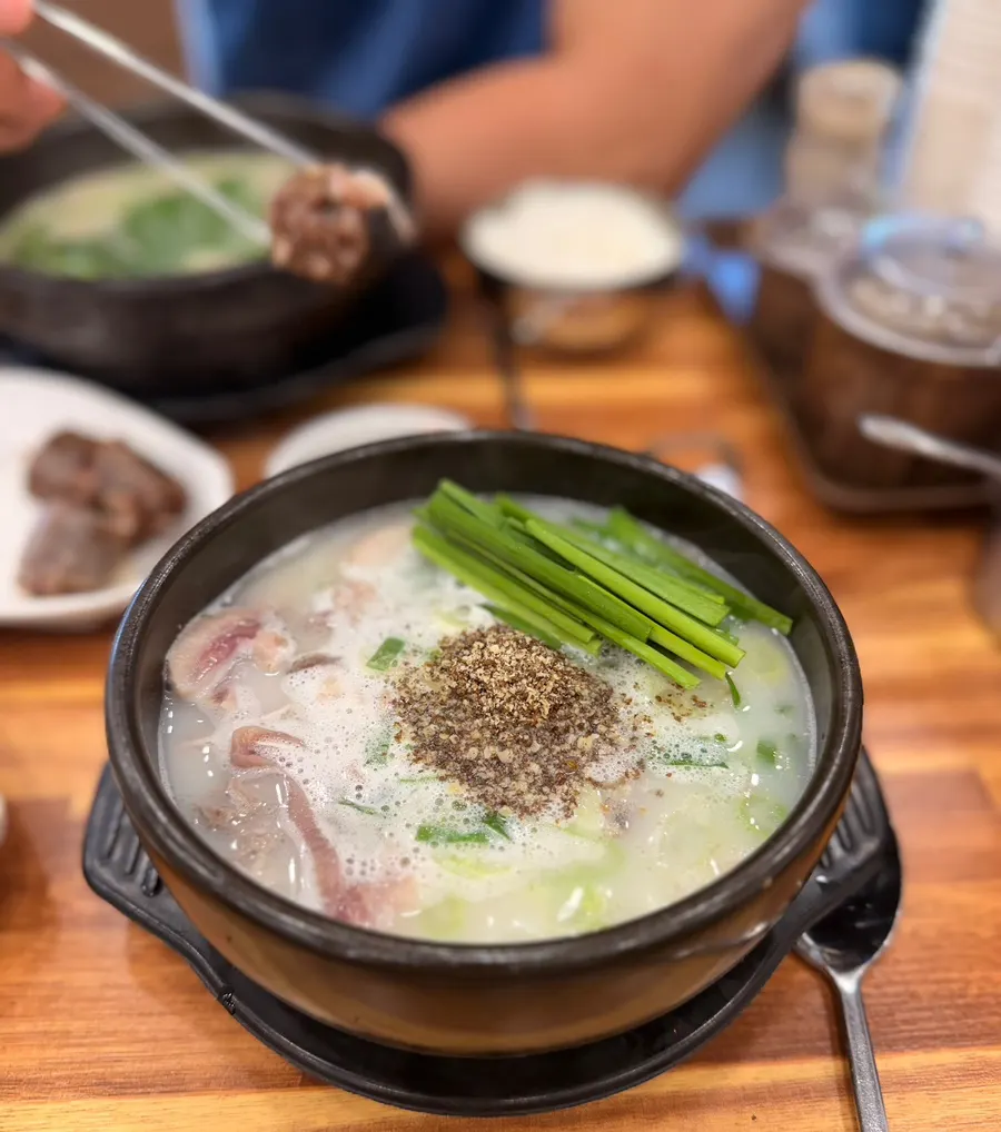 Sundae-guk topped with chives and perilla seed powder